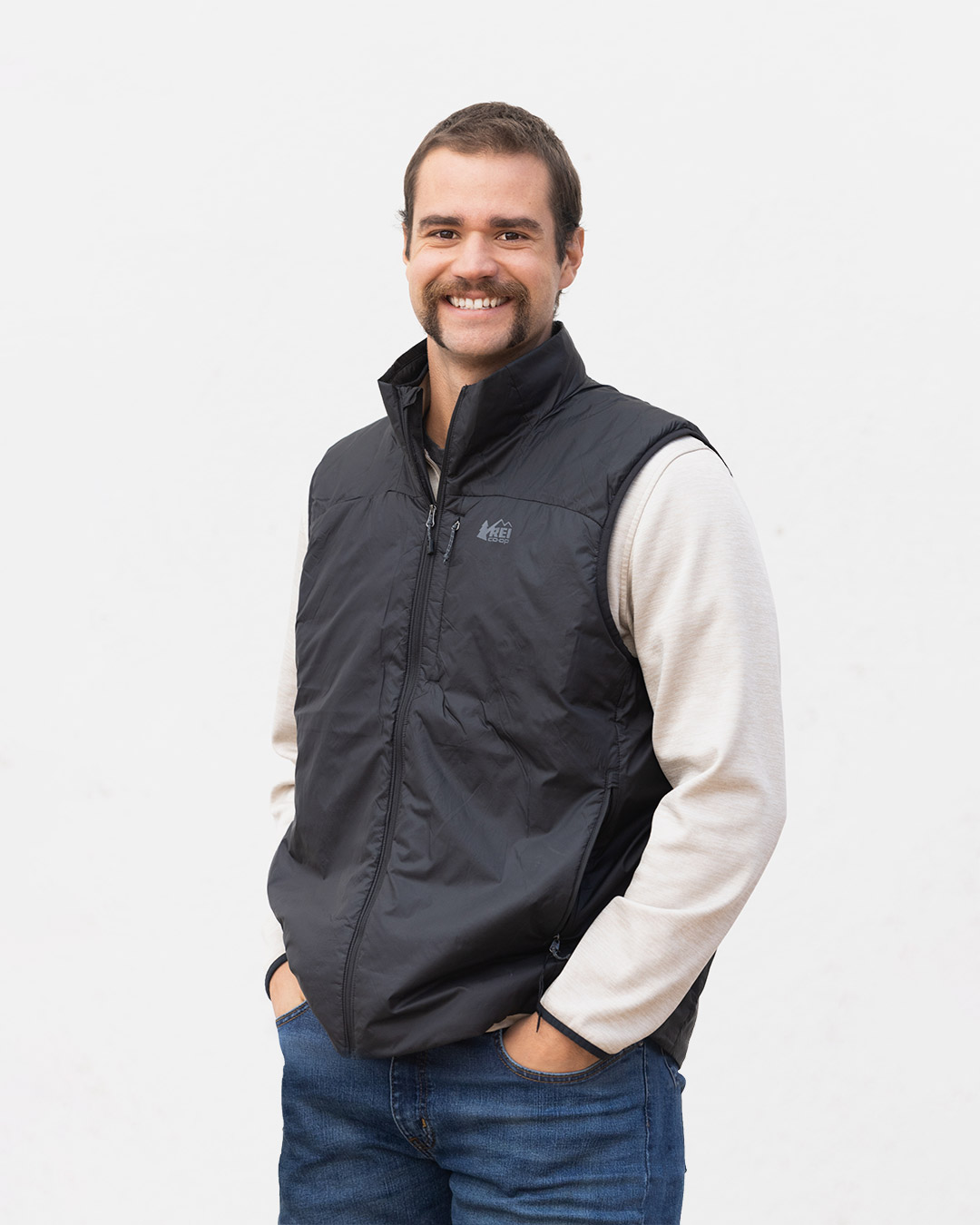 Joel Sawyer of Freestone Design-Build smiling for his team photo taken on a neutral white background