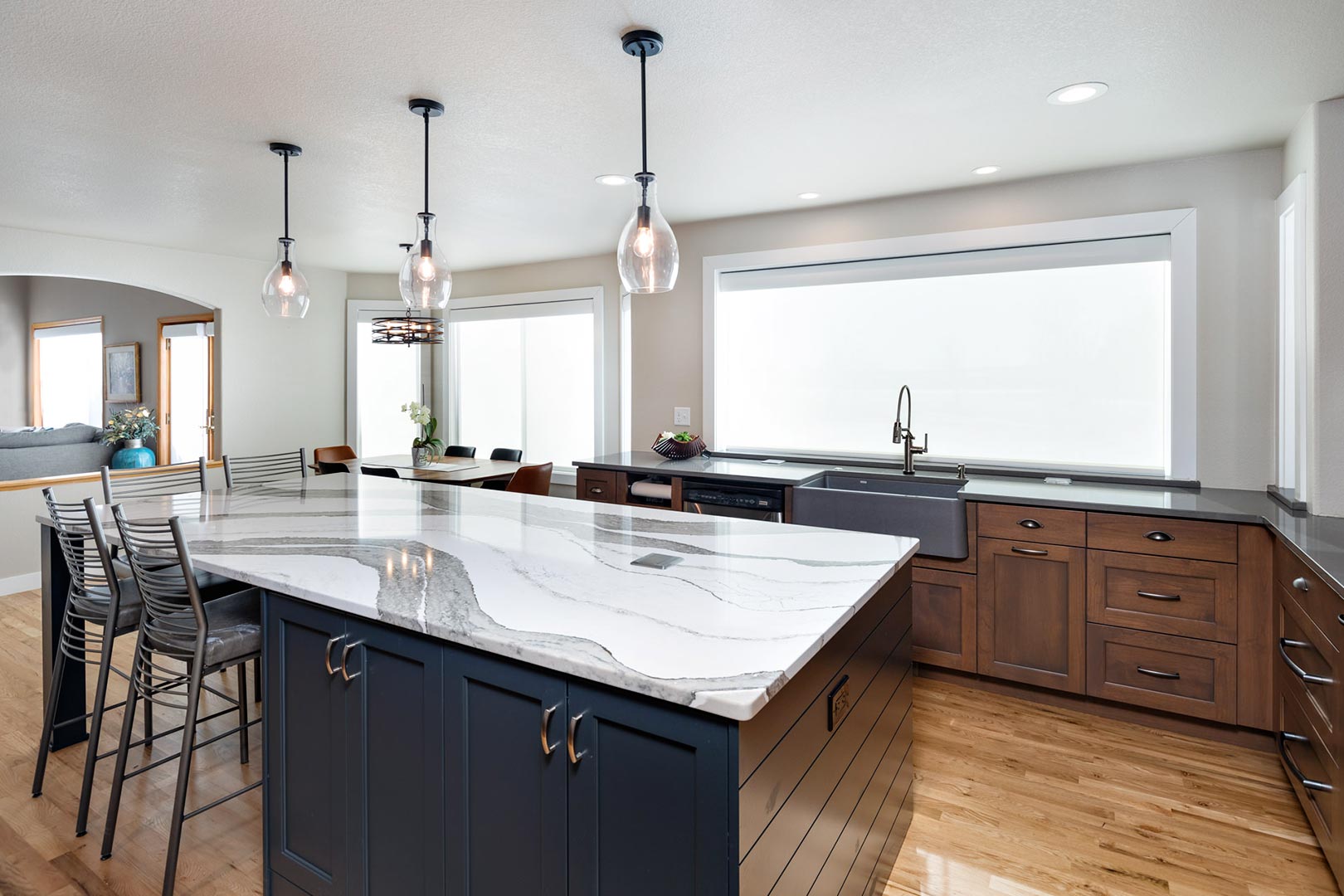A modern transitional farmhouse kitchen with a grand island in Fort Collins Colorado.