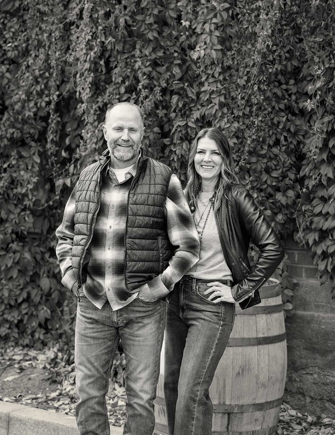 An inviting Scott and Cheri Freestone the founders of Freestone Design-Build standing together with big smiles and almost mid laugh. 