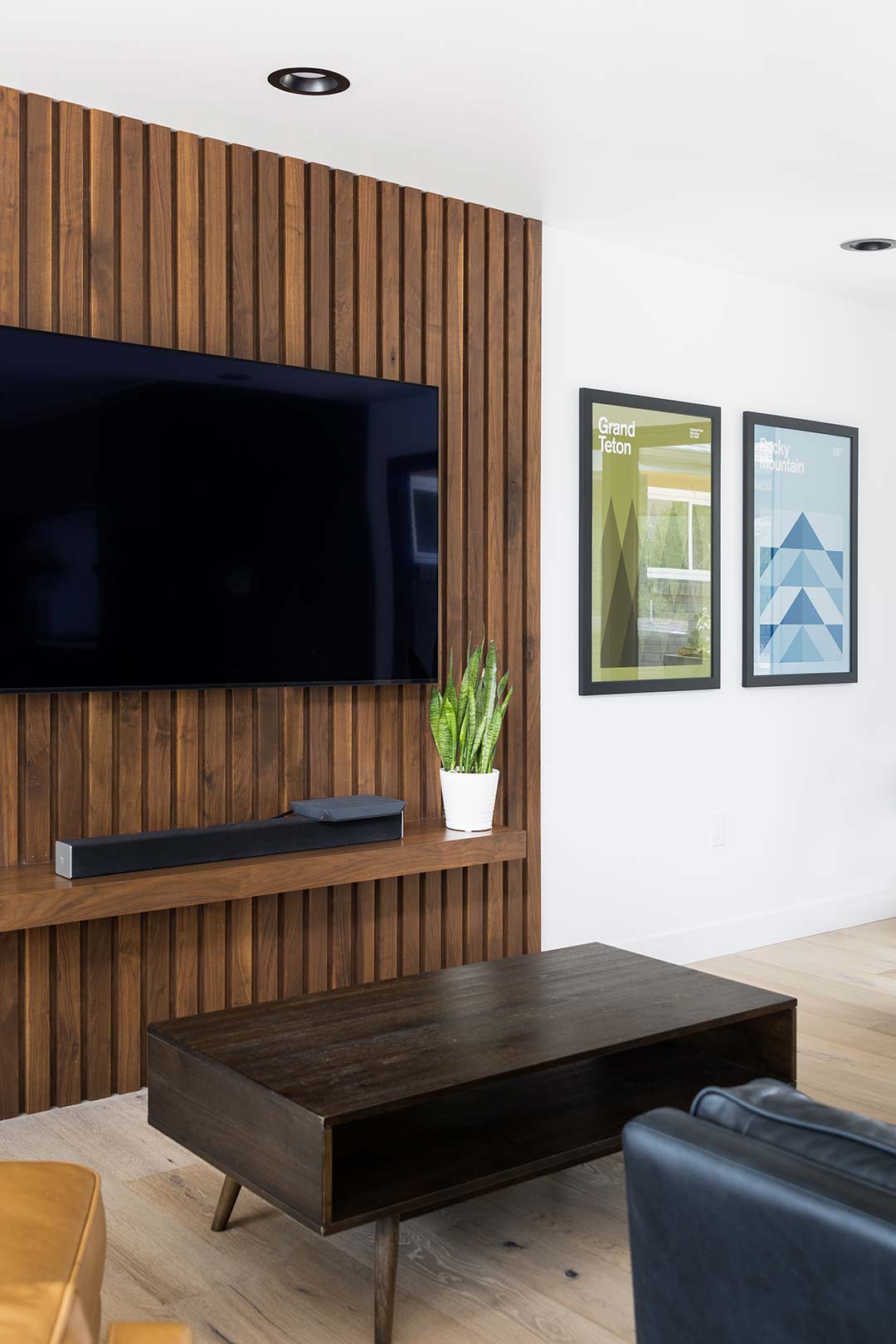 Additional view  of the living rooms custom wood slat feature accent wall behind the tv