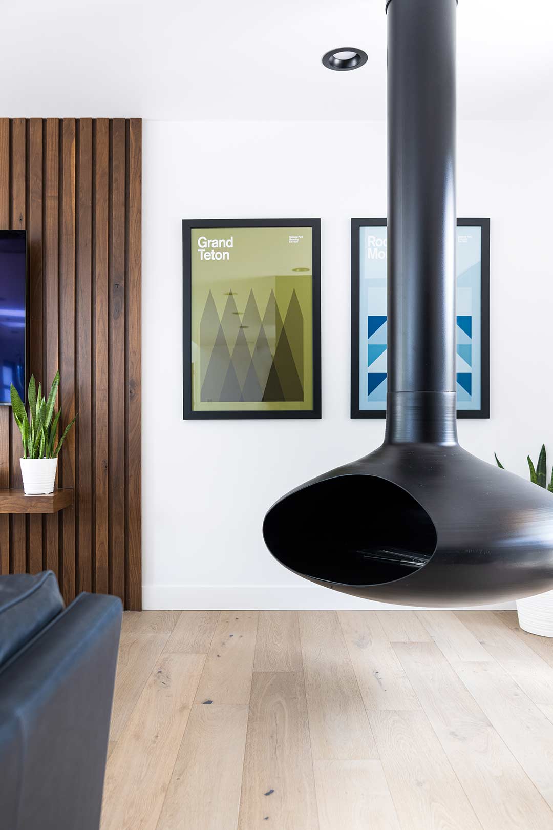 A floating modern biofuel fire orb, adding warmth and visual interest to this mid-century modern remodel's living room