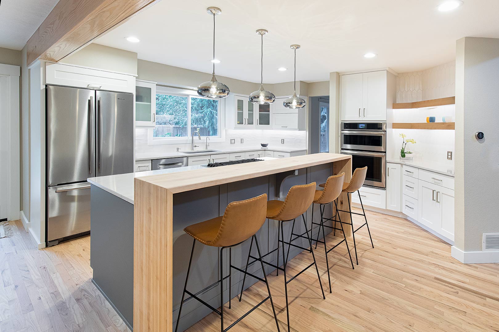 A transitional modern kitchen renovation showing a dual heigh island with bar seating in Fort Collins Colorado.