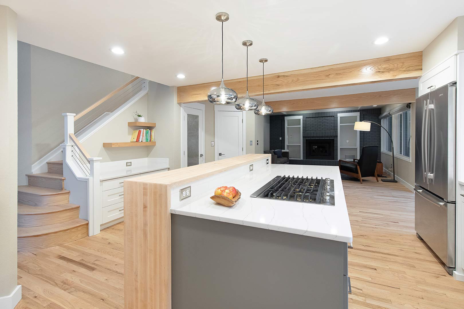 Wide angle view of the Shore Pine Drive transitional modern kitchen looking at the modern staircase update