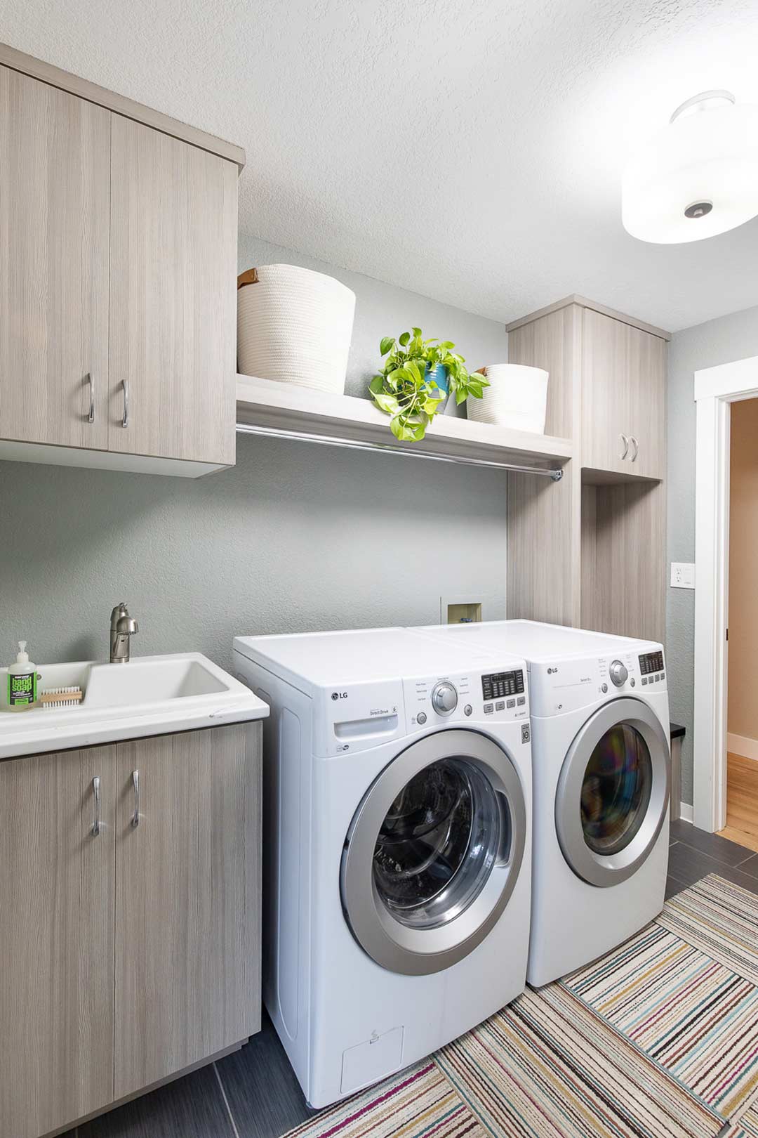 Laundry renovation  showing custom built in cabinets and modern open shelving