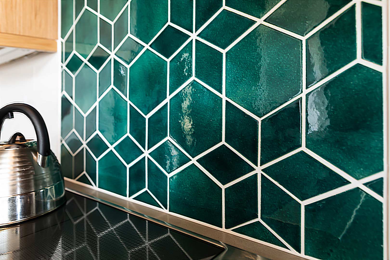 Detailed show of the custom backsplash mosaic tile installed in-house by Freestone Design-Build.