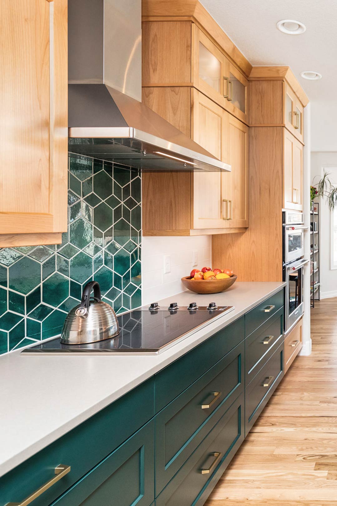 Custom green tile oven backsplash installed to mimic the vibrant green color used on the cabinets