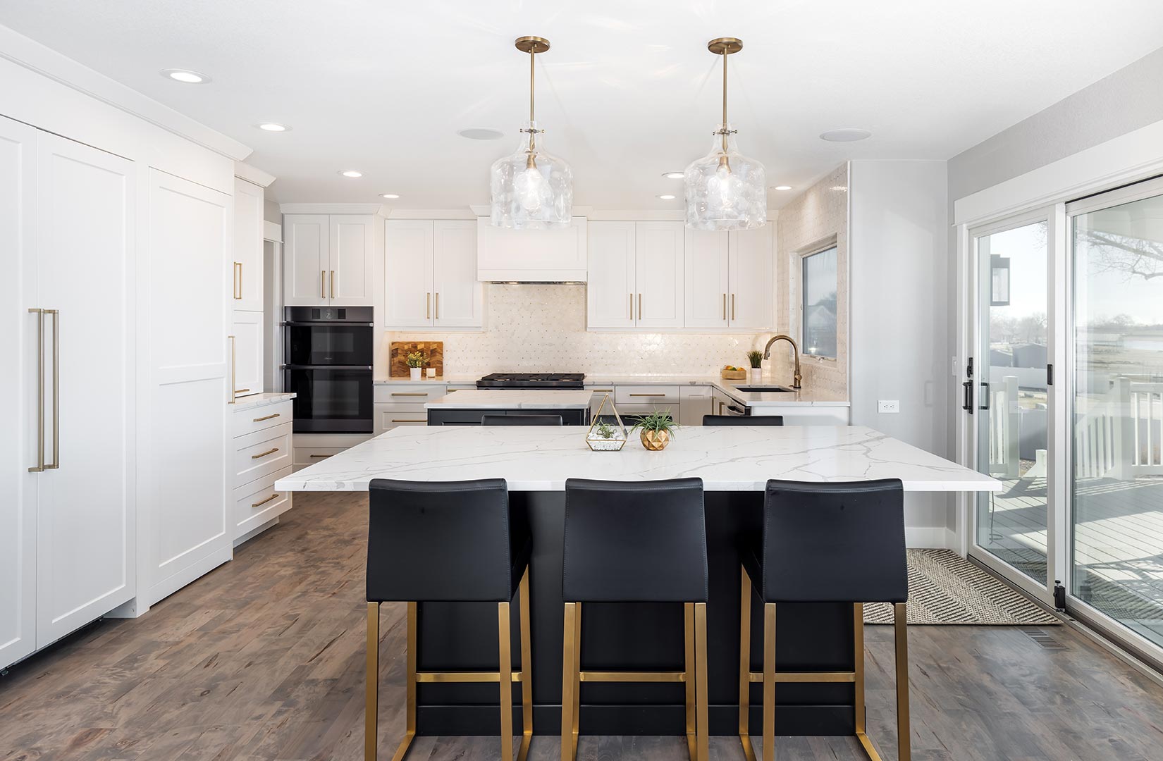 A wide angle view of a modern transitional kitchen with two islands in Loveland Colorado