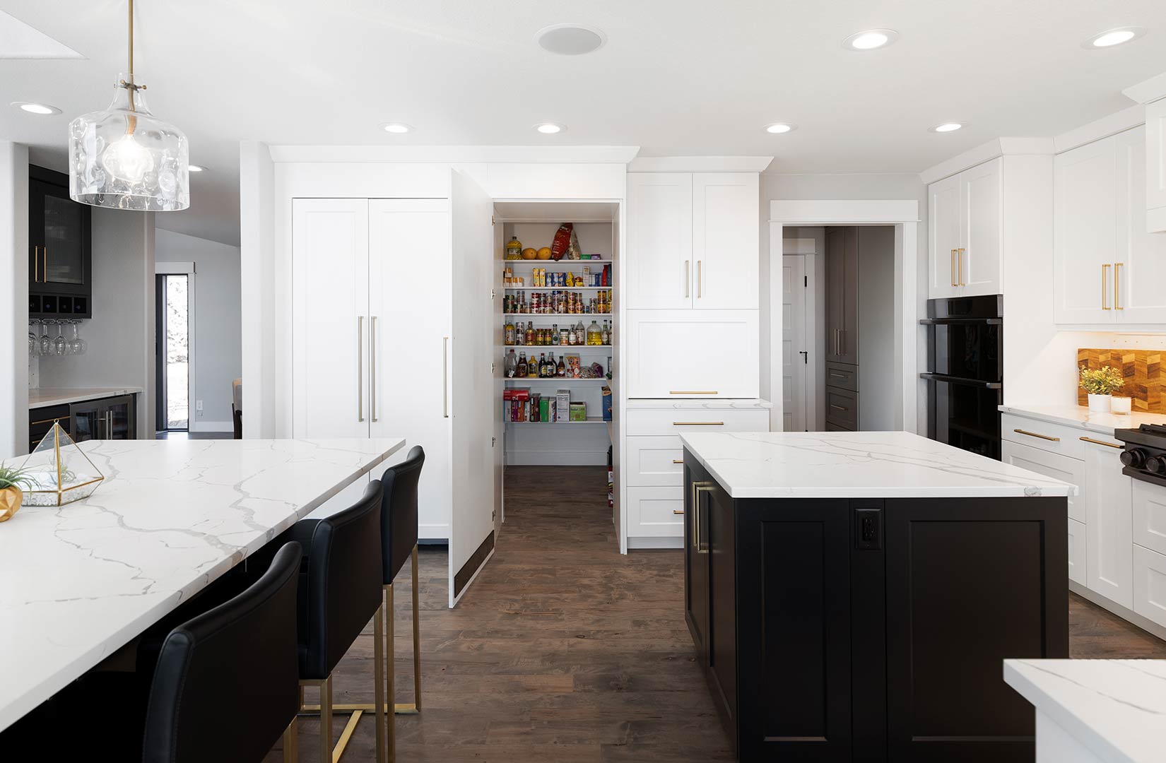 A wide angle view of the hidden pantry in Janna Drive project's modern kitchen