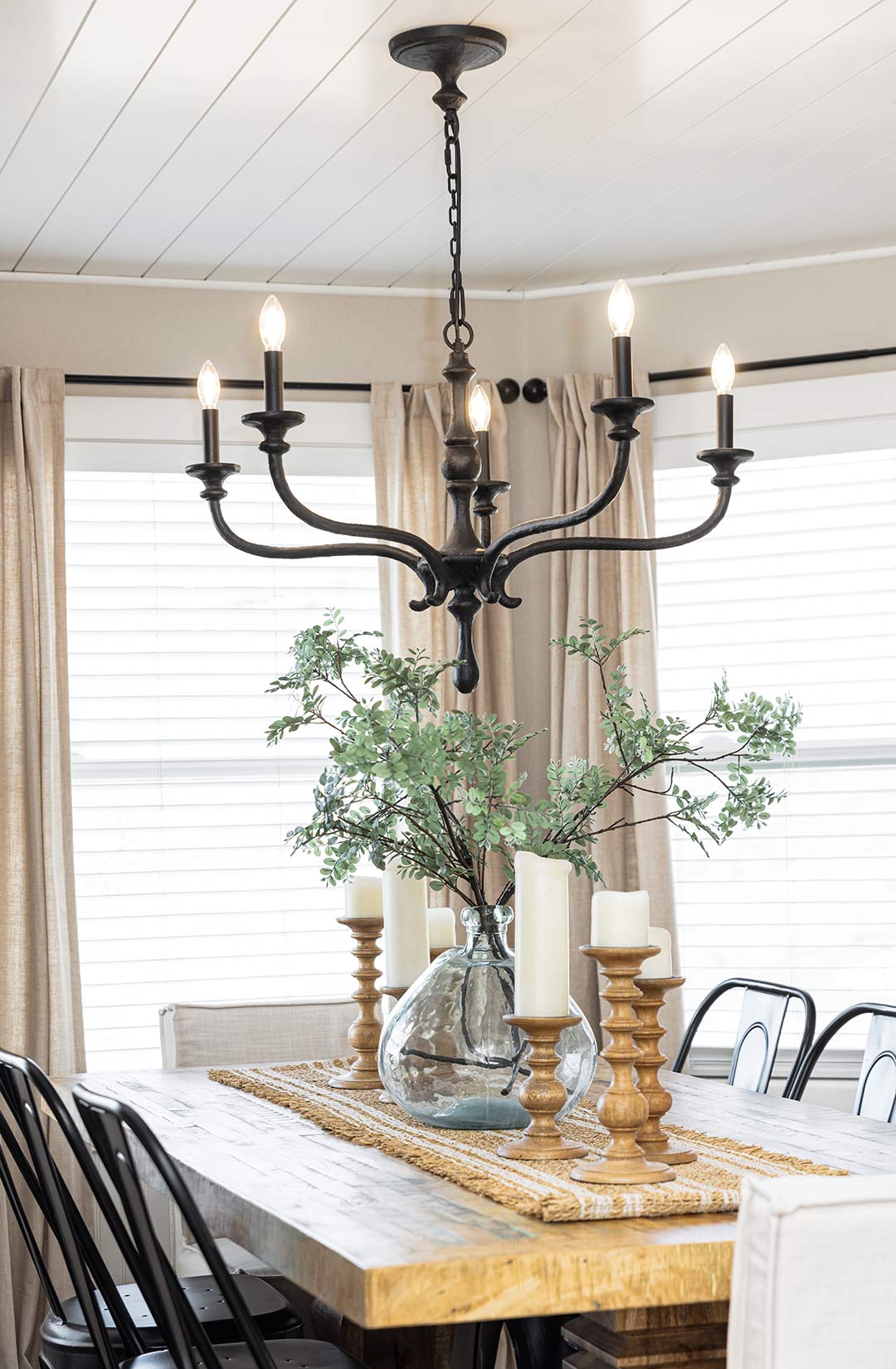 Industrial Farmhouse chandelier over a the table in the dining nook, stylized by Freestone Design-Build
